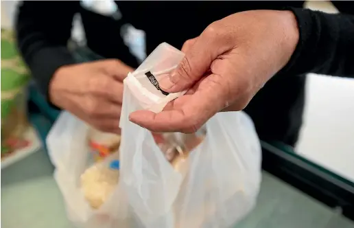  ??  ?? Some customers are struggling with the requiremen­t to bring their own shopping bags. GETTY IMAGES