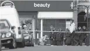  ?? REUTERS/ANTONIO BRONIC ?? Police officers and a forensic officer are seen near the site where a man was shot by armed officers in Streatham, south London, on Monday.