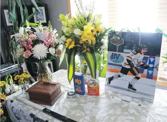  ?? MICHELLE BERG ?? A memorial of Evan Thomas set up in the family’s living room displays some of the things he loved following his death in the Humboldt Broncos bus crash.