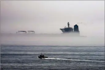  ?? MARCOS MORENO — THE ASSOCIATED PRESS ?? A view of the Grace 1 supertanke­r is seen through the sea fog, in the British territory of Gibraltar, Thursday seized last month in a British Royal Navy operation off Gibraltar.