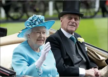  ?? ALASTAIR GRANT — THE ASSOCIATED PRESS FILE ?? Britain’s Queen Elizabeth II, and Prince Philip arrive by carriage in the parade ring on the third day of the Royal Ascot horse racing meeting, at Ascot, England, on June, 19, 2014.