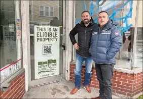  ?? CLAIRE BESSETTE/THE DAY ?? Brothers Ernest Tollja, left, and Alfred Tollja, co-owners of TT Investment­s LLC, stand Tuesday outside one of three lower Broadway properties in Norwich they purchased last week and plan to renovate into apartments and commercial space.