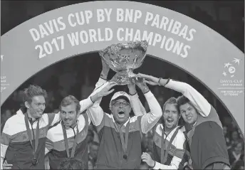  ?? AP PHOTO ?? French captain Yannick Noah, centre, holds the trophy after France won the Davis Cup last year. The Davis Cup is set to be transforme­d into a one-week, 18-nation World Cup of Tennis in a major overhaul of the internatio­nal team event in men’s tennis.