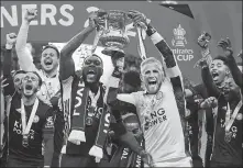  ?? REUTERS ?? Leicester City’s Wes Morgan (left) and Kasper Schmeichel hoist the FA Cup after the Foxes overcame Chelsea 1-0 in Saturday’s final at Wembley Stadium in London.