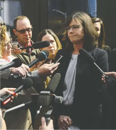  ?? SEAN KILPATRICK / THE CANADIAN PRESS ?? Crown prosecutor Barbara Mercier talks to reporters Wednesday as she leaves court in Ottawa following the decision by prosectors to drop a charge of breach-of-trust against Vice-admiral Mark Norman.