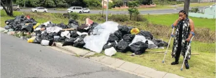  ?? Picture: SIPHOKAZI VUSO ?? ROTTEN BUSINESS: Bulelwa Sangqu next to the rubbish that she says residents in her area dump in front of her home