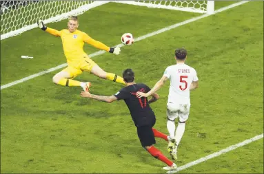  ?? Thanassis Stavrakis / Associated Press ?? Croatia’s Mario Mandzukic, center, scores his side’s second goal during Wednesday’s semifinal match against England.