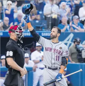  ?? FRED THORNHILL/THE CANADIAN PRESS ?? The Mets’ Jose Bautista acknowledg­es Blue Jays fans during his first at-bat Tuesday in his return to Toronto. The Jays topped the Mets 8-6.