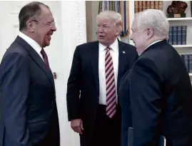  ?? —AP ?? The picture that painted a thousand words which left Trump redfaced. The US president meets with top Russian diplomats Sergey Lavrov (left) and Sergei Kislyak, who is suspected to be actually a spy for Russia.