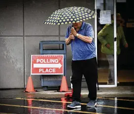  ?? ?? The rain on Tuesday did not slow down some voters from turning out at St. Helen School on Burkhardt Road in Riverside.