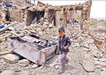  ?? Mohammed Huwais
AFP/Getty Images ?? HOUSES LIE IN RUINS a day after an airstrike by the Saudi-led coalition targeting Houthi insurgent positions was reported to have hit the village of Bani Matar, about 40 miles west of Sana, the Yemeni capital.