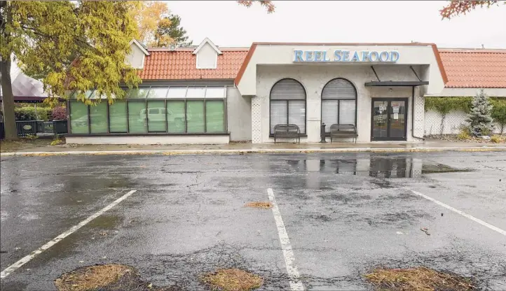  ?? Photos by Lori Van Buren / Times Union ?? The Reel Seafood is one of several businesses on Wolf Road that has closed recently. Despite the prime real estate, there’s a struggle at some locations to find new tenants.