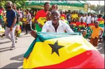  ?? ?? Ghana soccer fans celebrate their win in the World Cup Group H soccer match between Ghana and South Korea, played in Doha, next to a video screen erected outside the state broadcaste­r in the capital Accra, Ghana. (AP)