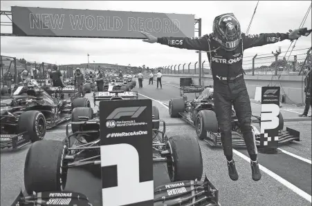  ?? AFP ?? Lewis Hamilton celebrates breaking Michael Schumacher’s all- time win record with victory at the Portuguese Grand Prix last Sunday.