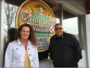  ?? RICHARD PAYERCHIN — THE MORNING JOURNAL ?? Krissi and Scotti Campana stand outside the sign for Campana’s Authentic Internatio­nal Cafe, 203 W. 8th St. in Lorain. The cafe will open there this spring, Scotti Campana said. Anyone who wants an early taste can sample Campana’s Authentic products noon to 3 p.m. at the Oberlin IGA, 331 E. Lorain St. in Oberlin.