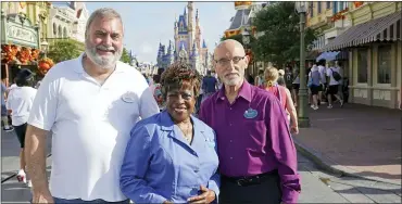  ?? JOHN RAOUX — THE ASSOCIATED PRESS ?? Walt Disney World employees from left, Chuck Milam, Earliene Anderson and Forrest Bahruth gather at the Magic Kingdom in Lake Buena Vista, Fla. to celebrate their 50years working at the park.