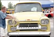  ??  ?? Don Greenlee of Tontitown dries off his 1959 Apache following a rain shower Saturday morning. Farmington High School sponsored the 13th annual Cardinal Car Classic with 37 registered vehicles.