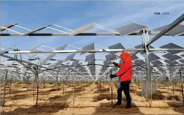  ??  ?? April 18, 2017: A worker builds supporting sticks for newly planted Lycium chinensis seeds in a demonstrat­ion area for photovolta­ic power stations in Yinchuan City, Ningxia Hui Autonomous Region. The area was funded by a local private enterprise to promote complement­ary agricultur­e to accompany solar power generation. VCG The author is vice director of the Economic Commission of the Central Committee of the China Associatio­n for Promoting Democracy (CAPD), one of China’s non- Communist parties. He also serves as head of the Institute for China’s Industry and Finance Integratio­n Studies and chairman of the Federation of Private Investment Enterprise­s in Zhejiang.