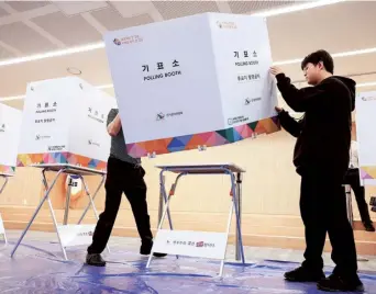  ?? REUTERS ?? Poll preparatio­n: Government officials set up a polling booth for the coming 22nd parliament­ary election at a learning centre in Seoul, South Korea, on Tuesday.