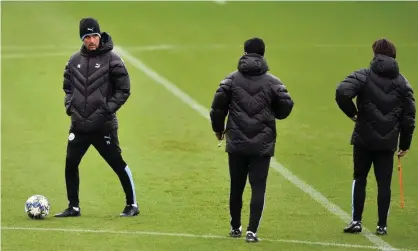  ??  ?? Manchester City’s manager Pep Guardiola and some of his backroom staff keep an eye on training in readiness for the Atalanta game on Tuesday. Photograph: Nathan Stirk/Getty Images