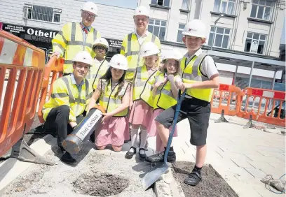  ??  ?? ●●Pupils from St Mary’s Primary burying the time capsule at the Redrock developmen­t with Councillor Alex Ganotis, Martyn Cox of George Cox & Sons and headteache­r Paul Towey