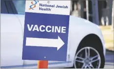  ?? AP PHOTO/DAVID ZALUBOWSKI ?? A sign directs motorist to a vaccinatio­n site at National Jewish Hospital on March 6 in east Denver. Merriam-Webster has declared vaccine its 2021 word of the year.