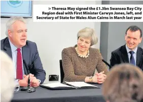  ??  ?? > Theresa May signed the £1.3bn Swansea Bay City Region deal with First Minister Carwyn Jones, left, and Secretary of State for Wales Alun Cairns in March last year