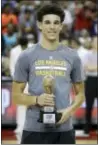  ?? THE ASSOCIATED PRESS ?? Lakers’ Lonzo Ball holds up the trophy for the most valuable player in the NBA summer league.