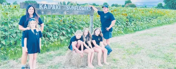  ?? ?? Tammy-Lee Grant (standing left) and Jeff Keesom (standing right), pictured with their children, are excited for the opening weekend of Kaipaki Sunflowers.