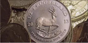  ?? PHOTO: BLOOMBERG ?? A half-ounce, 22 carat Krugerrand gold coin on display at the Sharps Pixley gold showroom in London. The precious metal posted the biggest weekly gain since August last week as escalating concerns about China’s outlook, a rout in equities and increased...