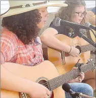  ??  ?? Remington of Lincoln has learned to play guitar through Roots Music, a free program sponsored by Historic Cane Hill through Inside Out Studio in Farmington.