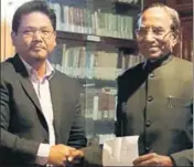  ?? HT PHOTO ?? Conrad Sangma (left) hands over a letter of support from 34 MLAs to Meghalaya governor Ganga Prasad at Raj Bhavan in Shillong on Sunday.
