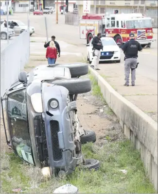  ?? Brodie Johnson • Times-Herald ?? Forrest City’s first responders were called to this accident scene on East Broadway Thursday afternoon when this vehicle drove off the roadway and overturned. According to officials at the scene, a child was also in the vehicle but was uninjured, as was the driver.