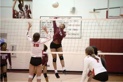  ?? Staff photo by Kelsi Brinkmeyer ?? ■ Arkansas High player Keonnie Strickland hits the ball over the net at their match against White Hall on Tuesday at Razorback Gymnasium in Texarkana.