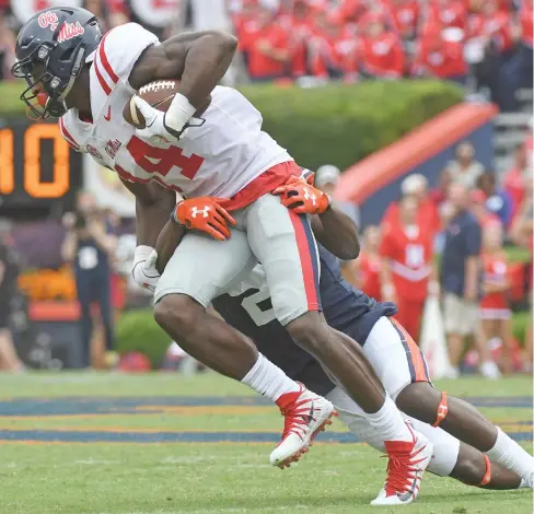  ?? Thomas Graning, AP) (Photo by ?? Auburn defensive back Traivon Leonard tackles Ole Miss wide receiver D.K. Metcalf (14) during the second half of Saturday's game.