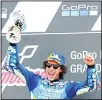  ??  ?? Spain rider Alex Rins of the Team SUZUKI ECSTAR celebrates with trophy on the podium after winning the MotoGP race at the British Motorcycle Grand Prix at the Silverston­e racetrack in Silverston­e,
England on Aug 25. (AP)