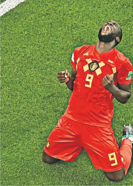  ??  ?? Epic: Striker Romelu Lukaku celebrates Belgium’s victory as Shinji Okazaki of Japan (below) consoles Takashi Inui