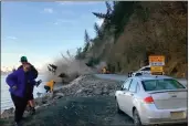  ?? JOSH GRAY VIA AP ?? People run from a landslide just outside the downtown area of Seward, Alaska.