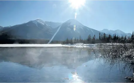  ?? POSTMEDIA NETWORK FILES ?? Mist rolls off a patch of water kept ice free by hot springs at Vermilion Lakes near Banff, Alta.
