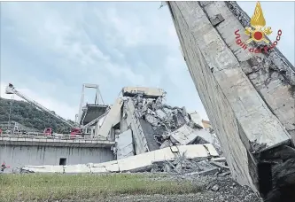  ?? THE ASSOCIATED PRESS ?? In this photo released by firefighte­rs, rescue teams work among the rubble of the collapsed bridge Tuesday.