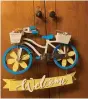  ?? (Special to The Commercial) ?? Progressiv­e Women’s Associatio­n member Brenda Doucey was happy with the bicycle-themed welcome sign she purchased at the White Elephant Auction.