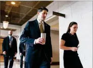  ?? ANDREW HARNIK AP PHOTO BY ?? House Speaker Paul Ryan of Wis., center, accompanie­d by his Press Secretary Ashlee Strong, right, walks to the Capitol Building from the Capitol Visitor's Center, Thursday in Washington.