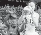  ?? By Steve Bisig, US Presswire ?? Taking a hit: Storm center Ann Wauters is fouled Sunday by Mystics guard Matee Ajavon.