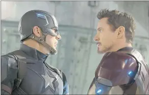  ??  ?? Chris Evans as Captain America, left, and Robert Downey Jr. as Iron Man have a difference of opinion in Captain America: Civil War.