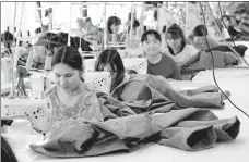  ?? CUI JIA / CHINA DAILY ?? Women work at the Eagle Textile company’s factory in Yarkant county, Xinjiang Uygur autonomous region, in May.