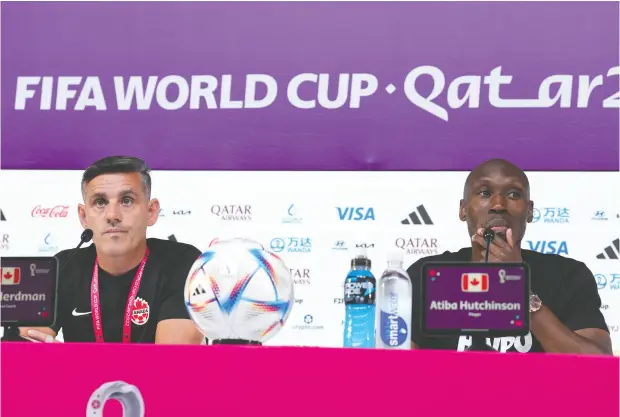  ?? NATHAN DENETTE / THE CANADIAN PRESS ?? Canada head coach John Herdman and captain Atiba Hutchinson speak during a news conference Tuesday ahead of Wednesday’s match against
Belgium at the World Cup. The midfielder will be appearing in his 99th game in a Team Canada jersey.