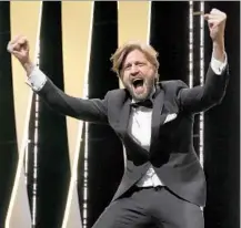  ??  ?? DIRECTOR Ruben Östlund exults after his film won the Palme. In fact, he called for a “primal scream of happiness.”