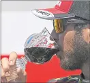  ??  ?? Martin Truex Jr. drinks from the Champion’s Goblet as he celebrates his third win of the season, and second triumph in three weeks.