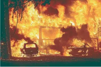  ?? AP ?? Flames consume a home on Highway 89 as the Dixie fire tears through the Greenville community of Plumas County, California.