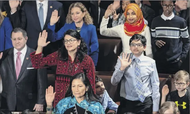  ?? J. Scott Applewhite / Associated Press ?? Democratic members of the House of Representa­tives take the oath Jan. 3 on the opening day of the 116th Congress. Top row: Rep. Debbie Wasserman Schultz, D-fla., left, and Rep. Ilhan Omar, D-minn., middle row, Rep. Joe Morelle, D-N.Y., left, and Rep. Rashida Tlaib, D-mich. Bottom row, Rep. Deb Haaland, D-N.M., the first Native American woman elected to Congress. They are joined by children and family members, a tradition on the first day of the new session.